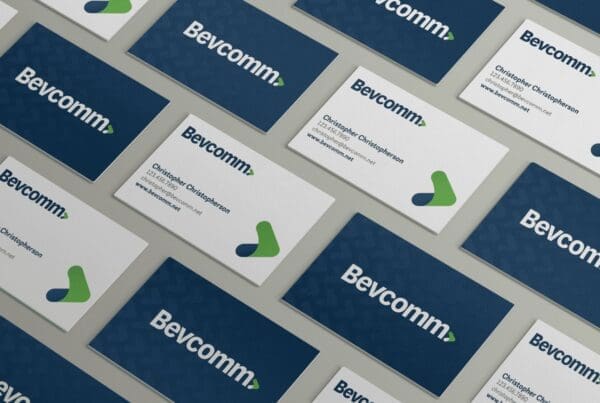 Mockup of business cards for Bevcomm, showing a pattern design on a light background.