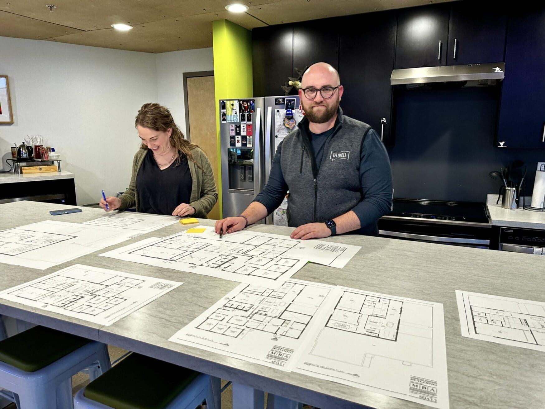 Annie and Max discussing blueprints